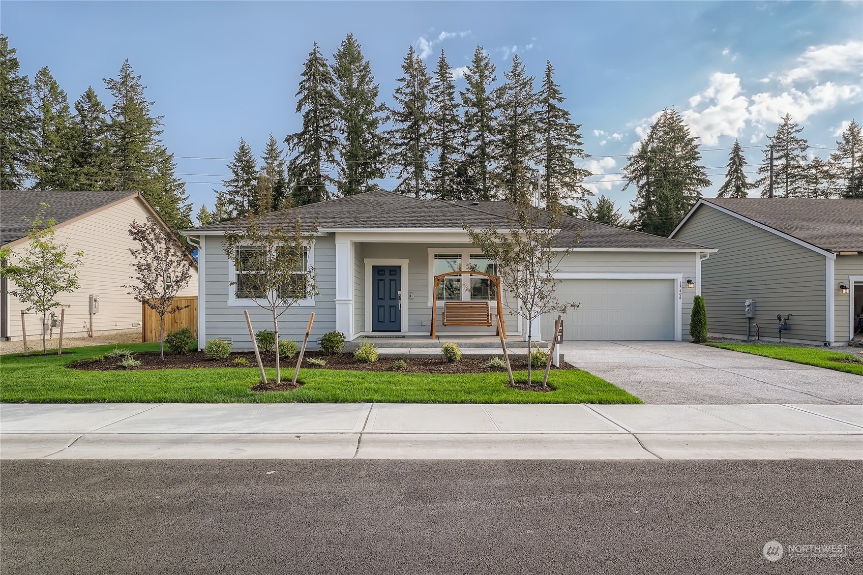 a front view of house with garage and green space