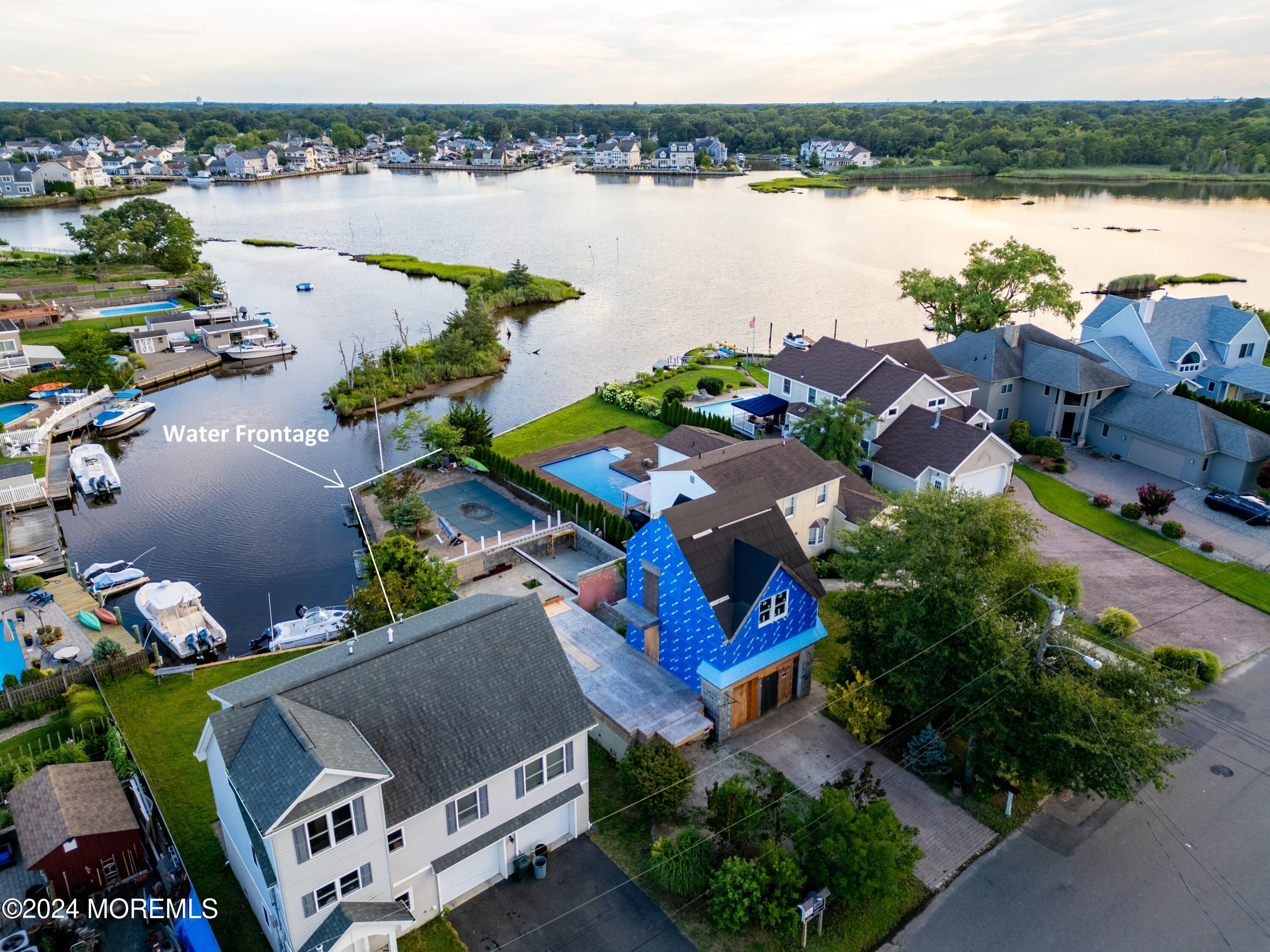 an aerial view of a house with outdoor space and lake view