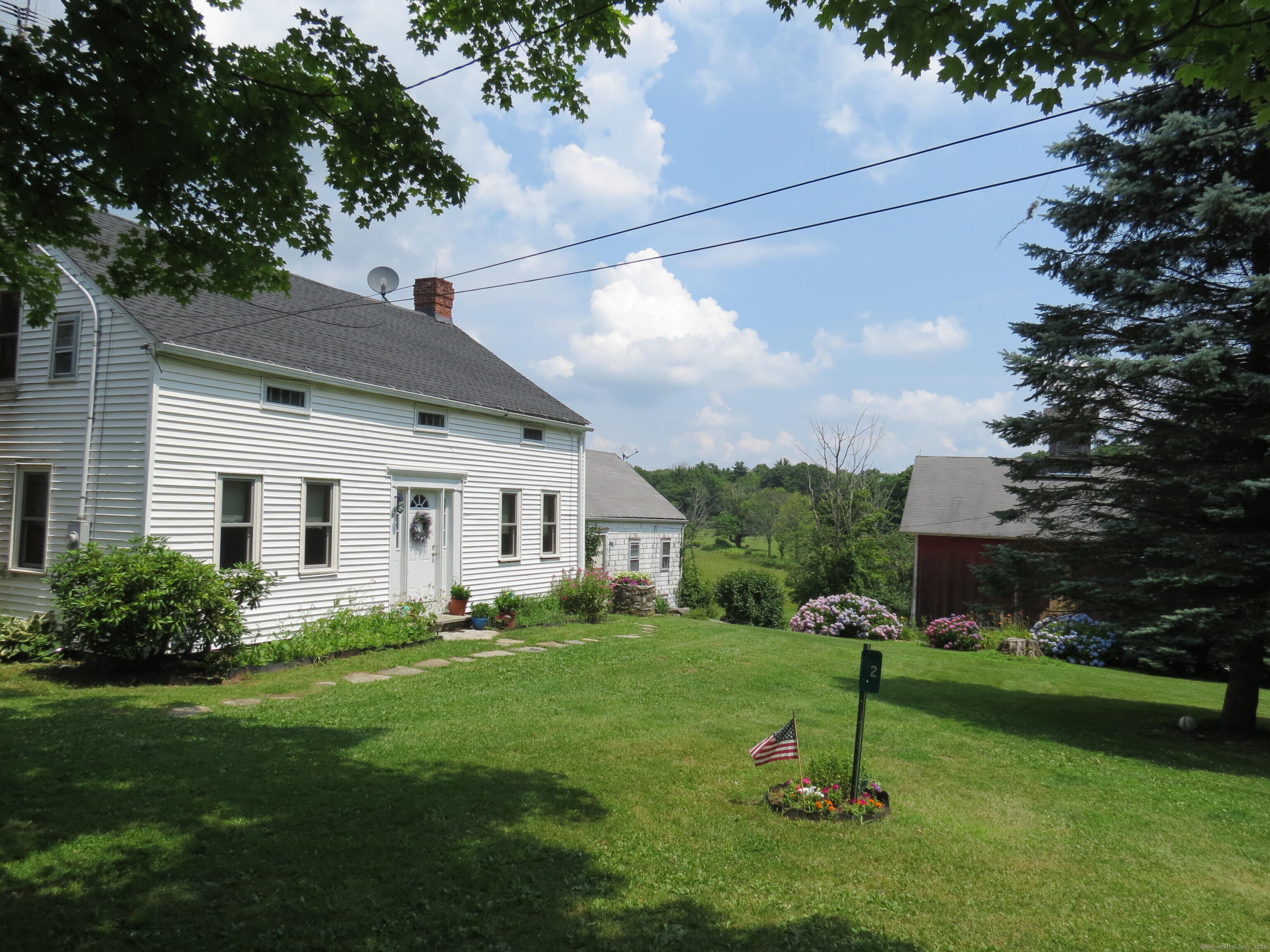 a front view of house with a garden