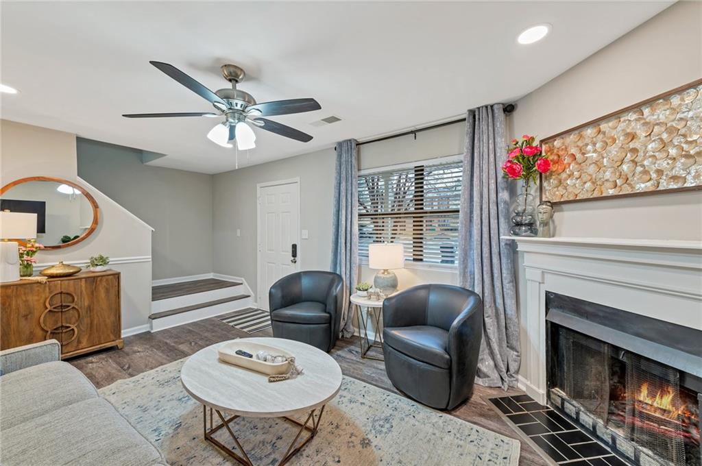 a living room with furniture a fireplace and a flat screen tv