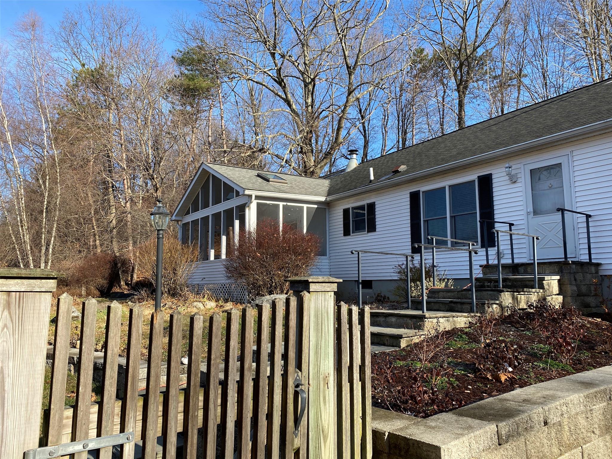 a front view of house with yard and trees around