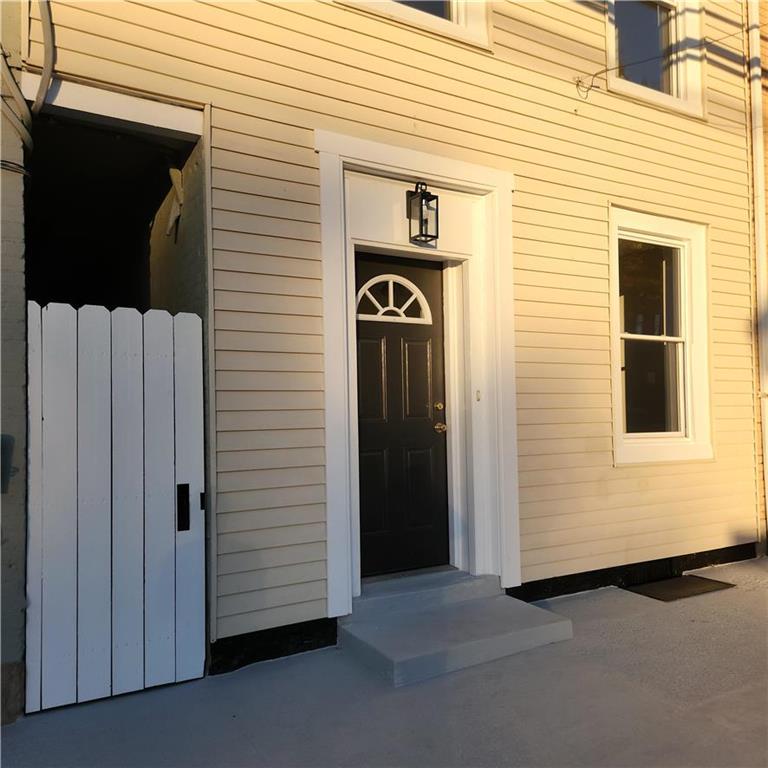 a view of a house with a door and wooden wall