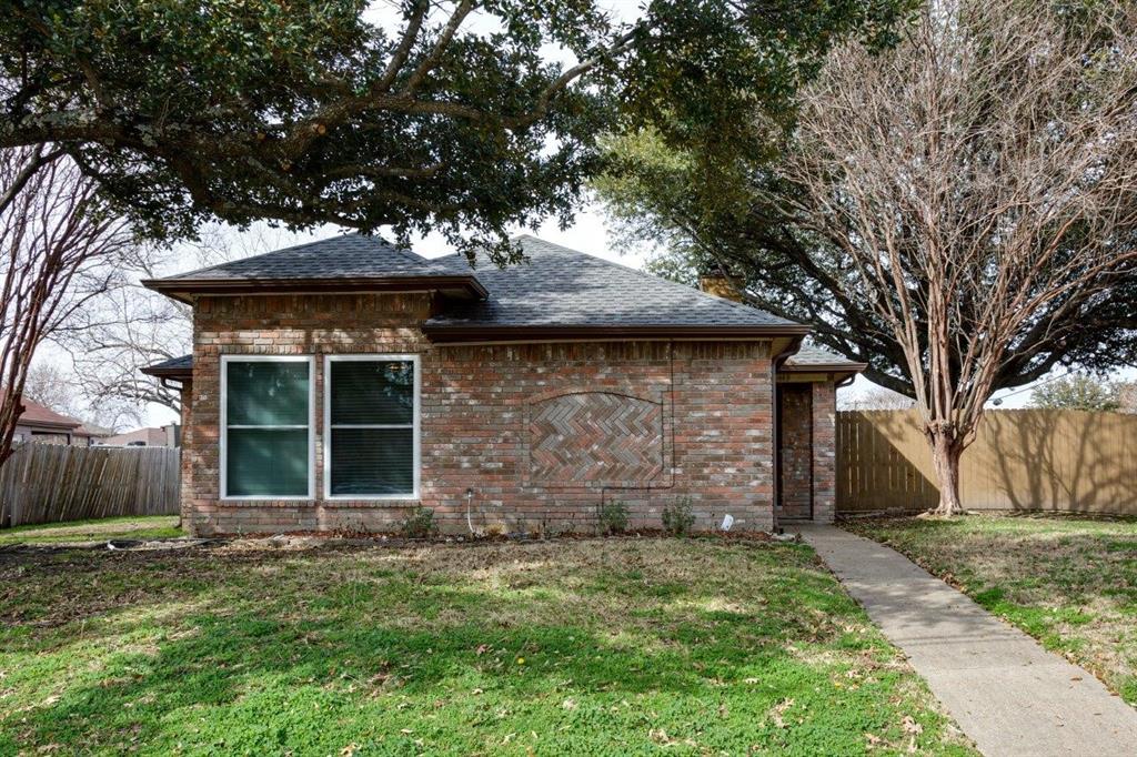 front view of a house with a tree