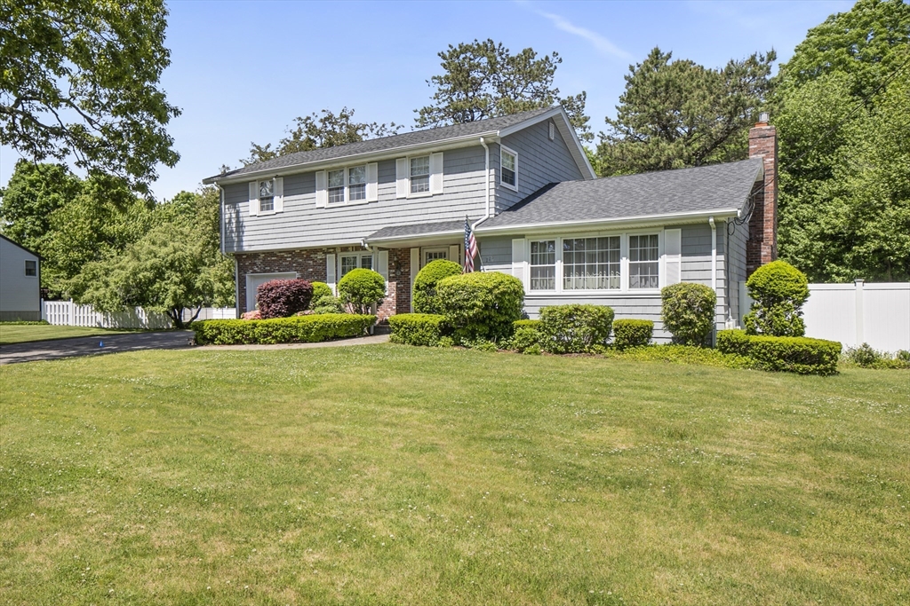 a front view of house with yard and green space