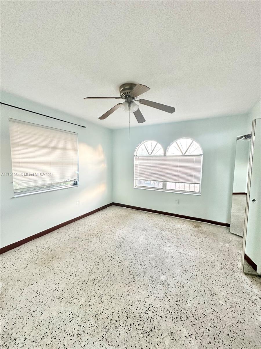 a view of a ceiling fan and a window