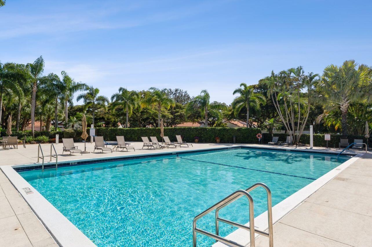 a view of a swimming pool and lounge chairs