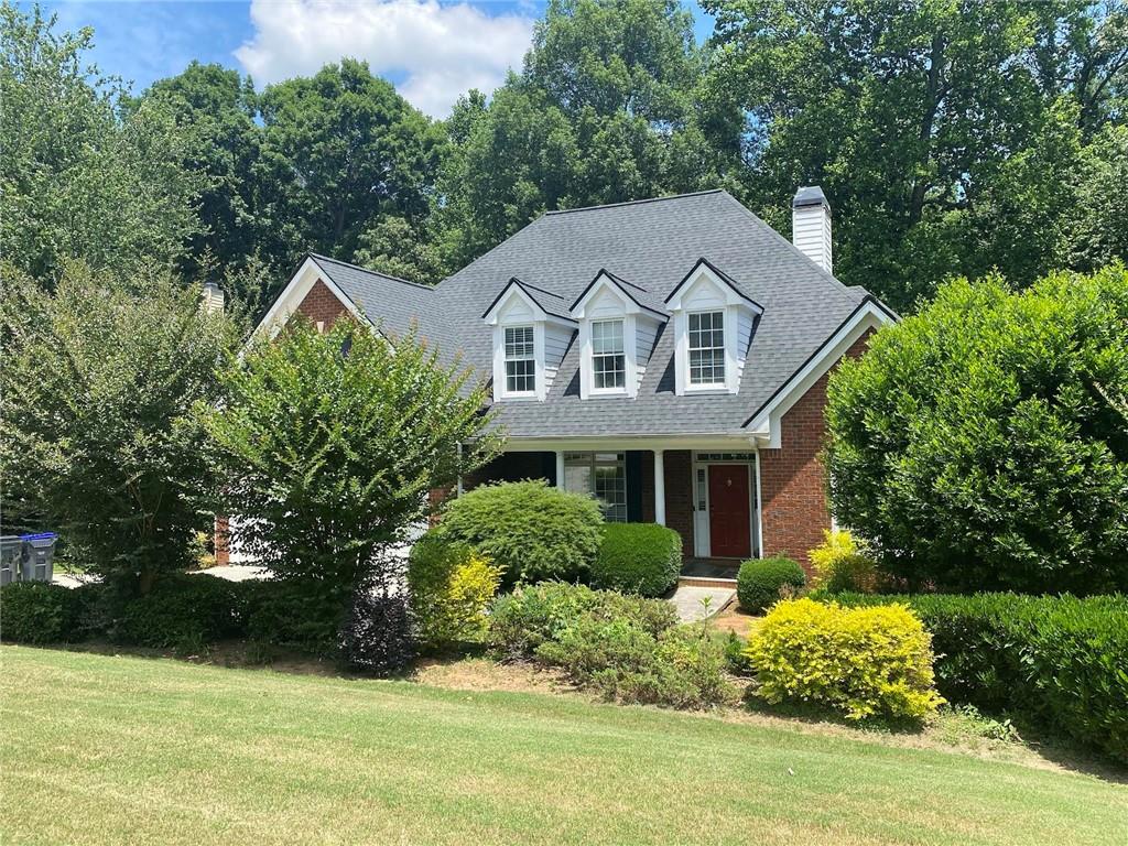 a front view of a house with a garden