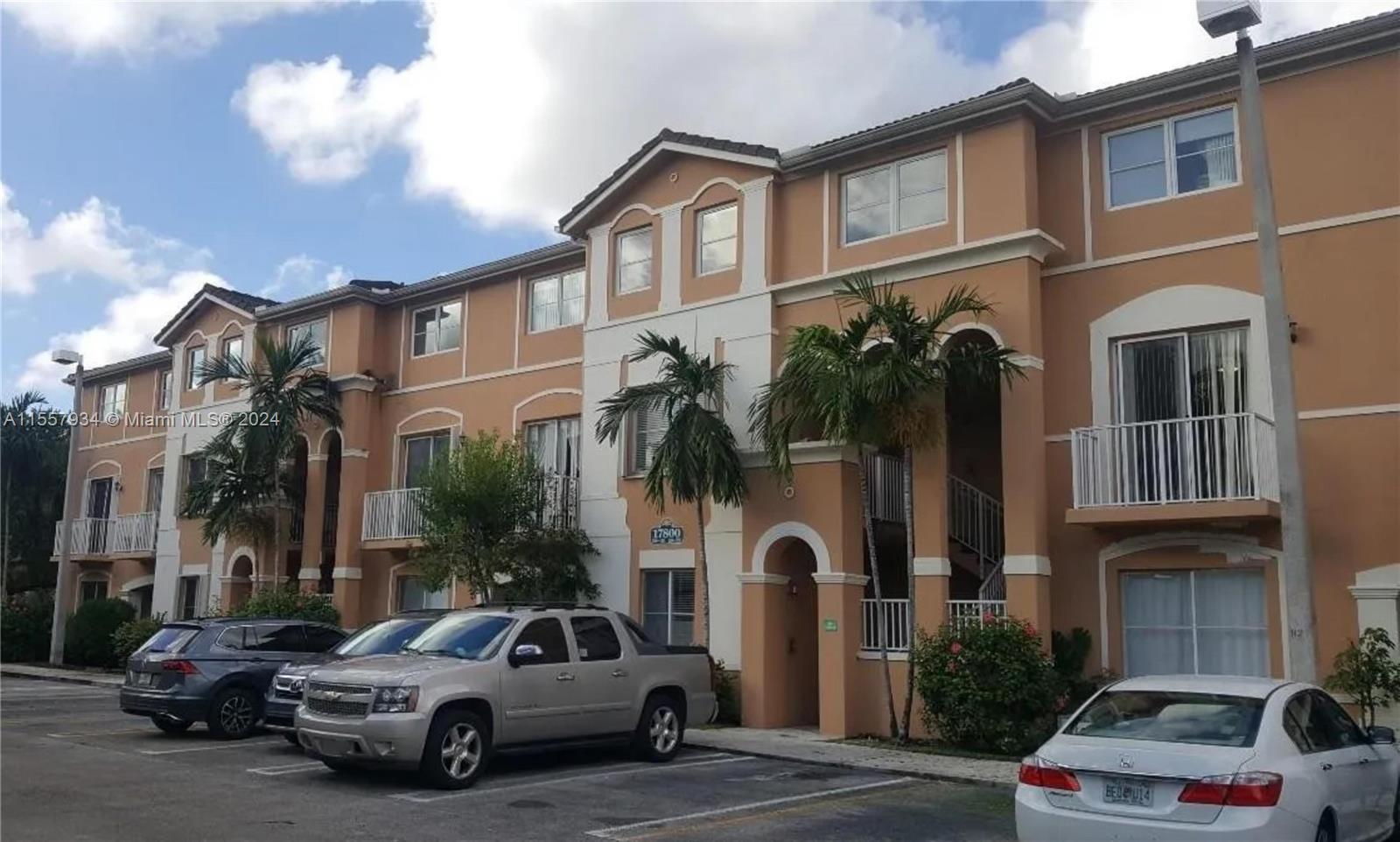 a view of multiple houses with a cars park