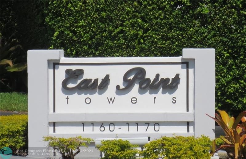 a black and white wall of a building with sign board