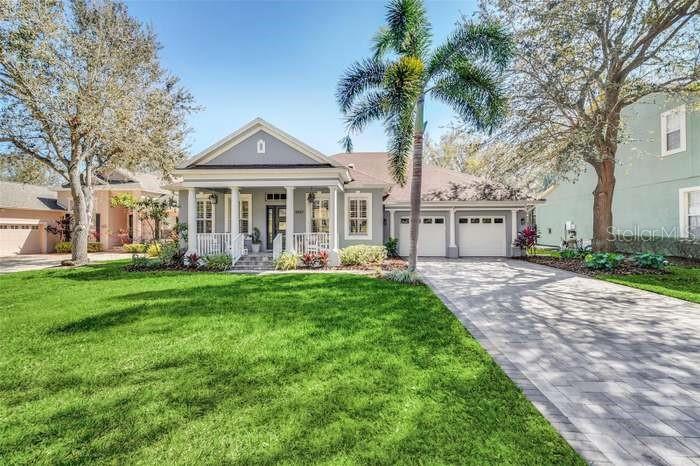 a view of a house with a yard and a garden