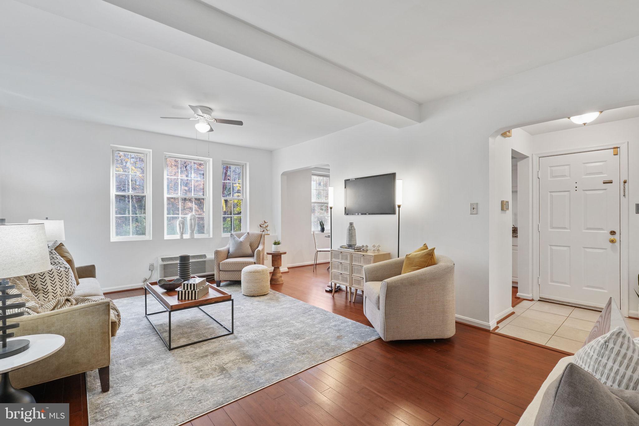 a living room with furniture and wooden floor