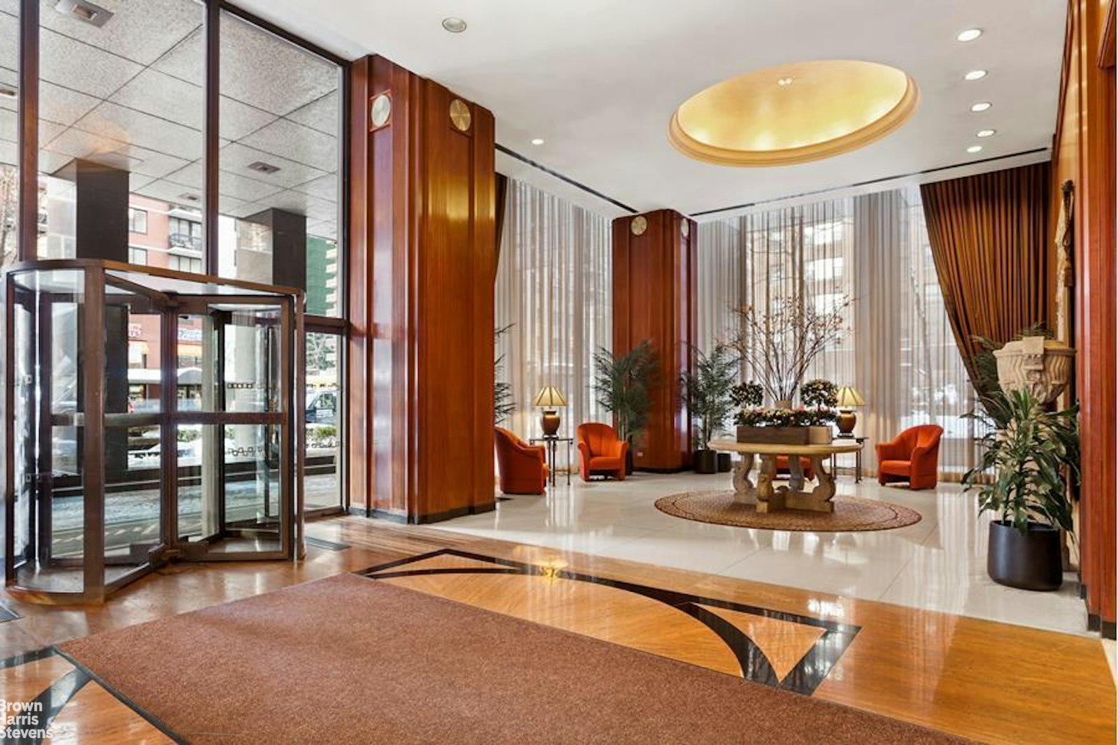 a lobby with furniture and floor to ceiling windows