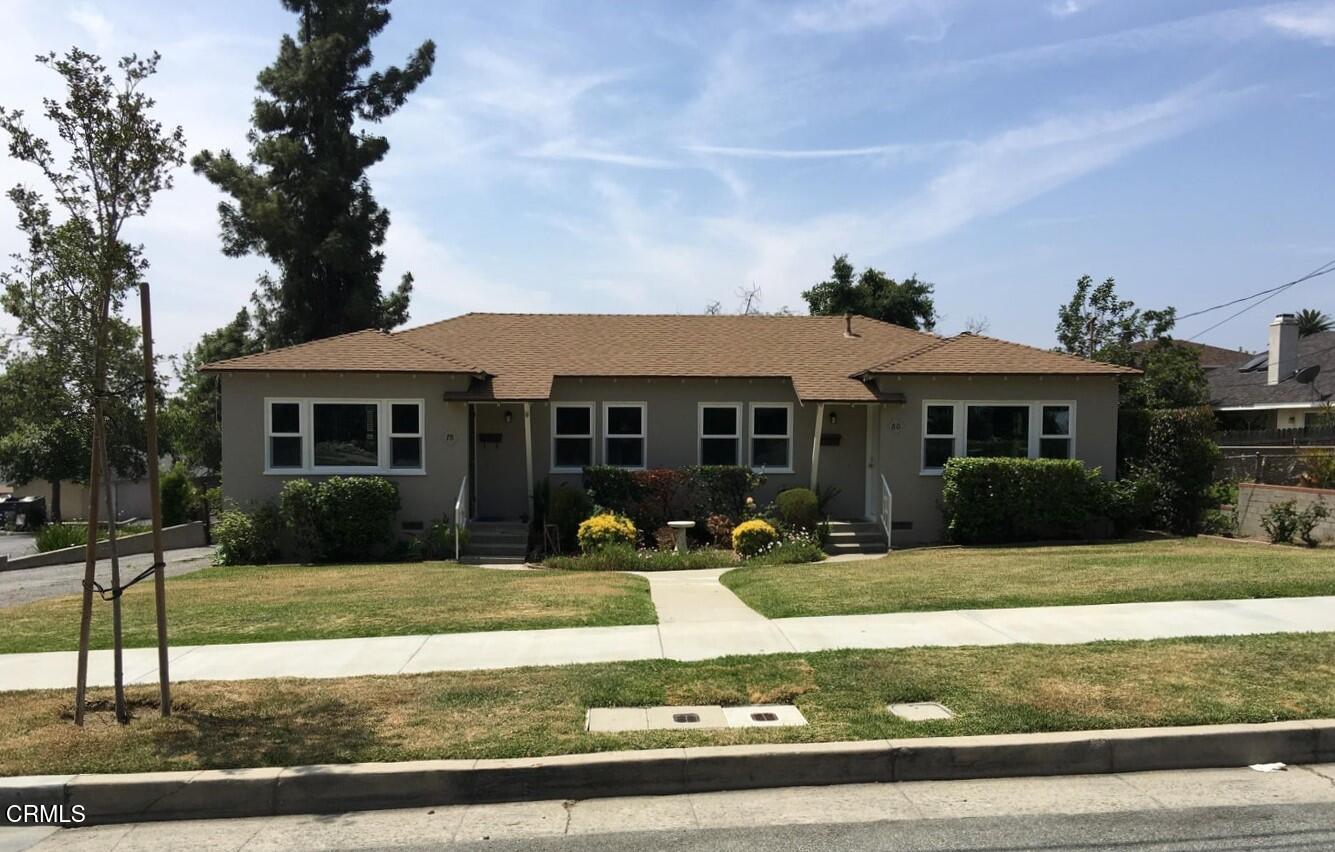 a front view of a house with garden