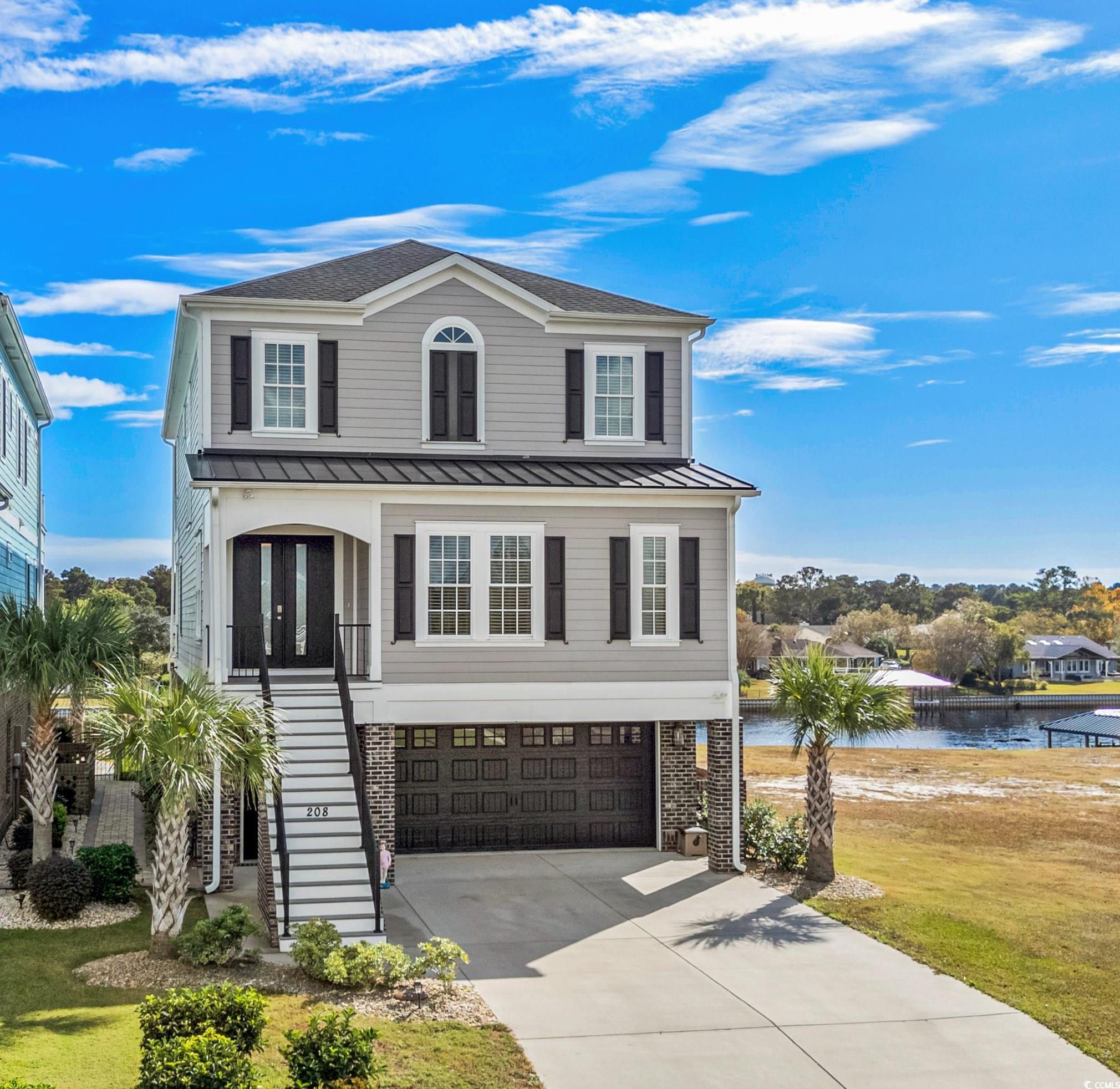 View of front of property with a garage, a front l