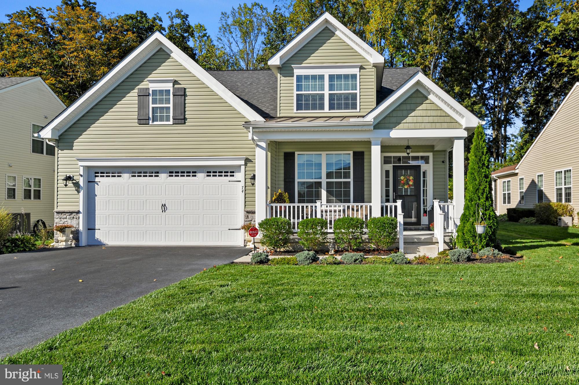 a front view of a house with a yard and porch