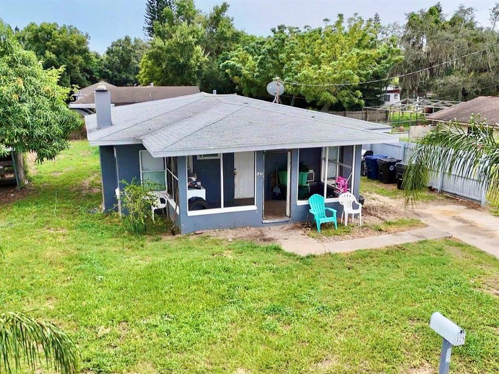 a view of a house with backyard porch and sitting area