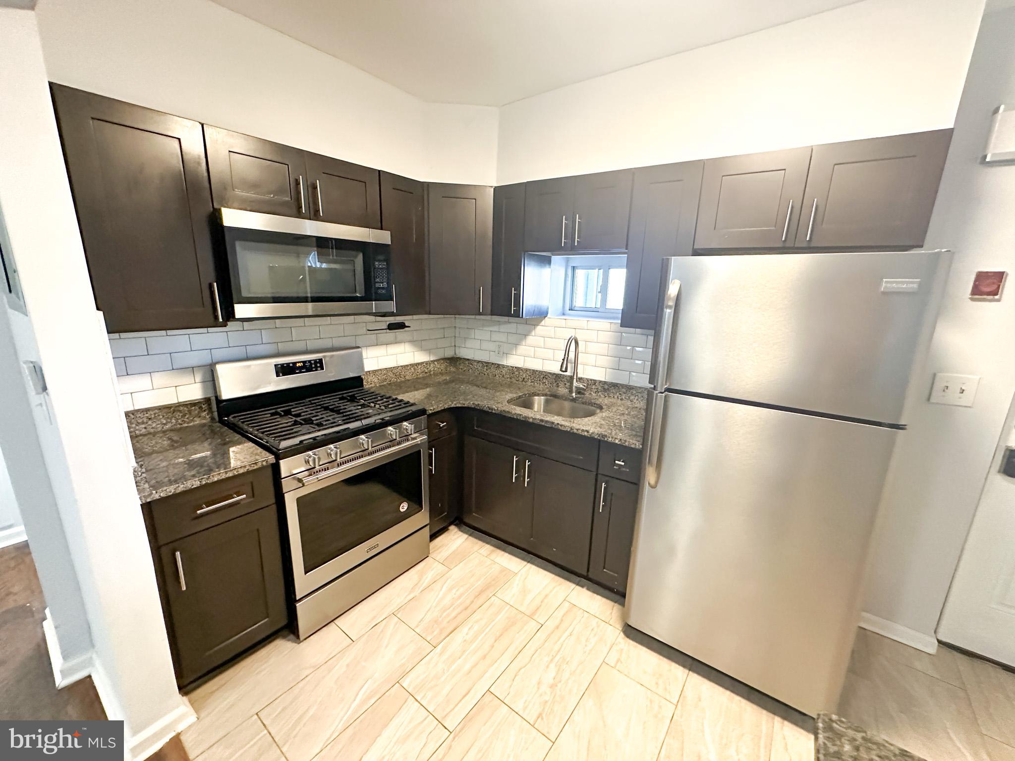 a kitchen with a refrigerator stove and microwave