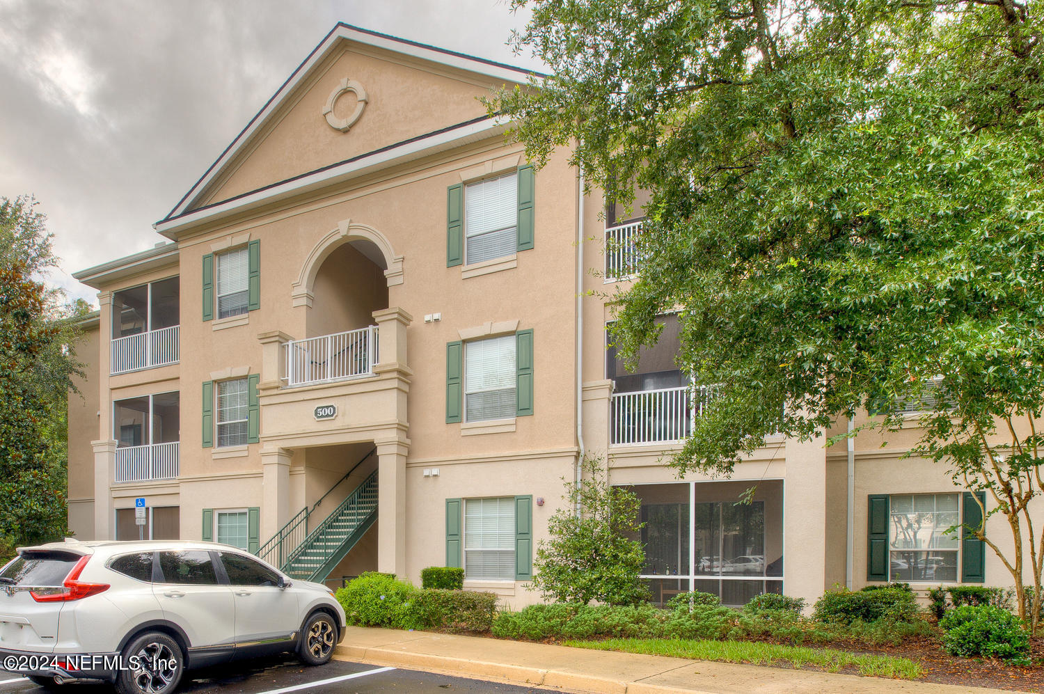 a front view of a residential apartment building with a yard