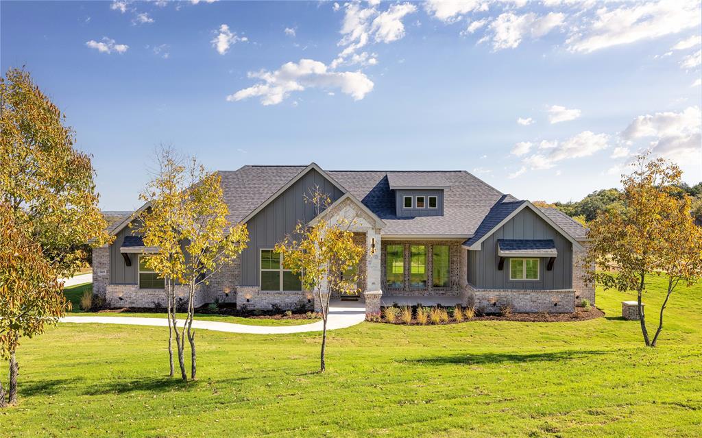 a front view of house with yard and swimming pool