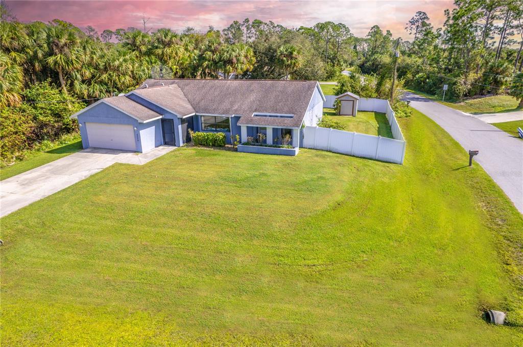 a view of a house with pool and a yard