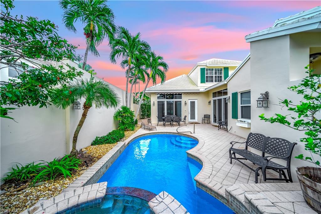 a view of a house with swimming pool and porch with furniture