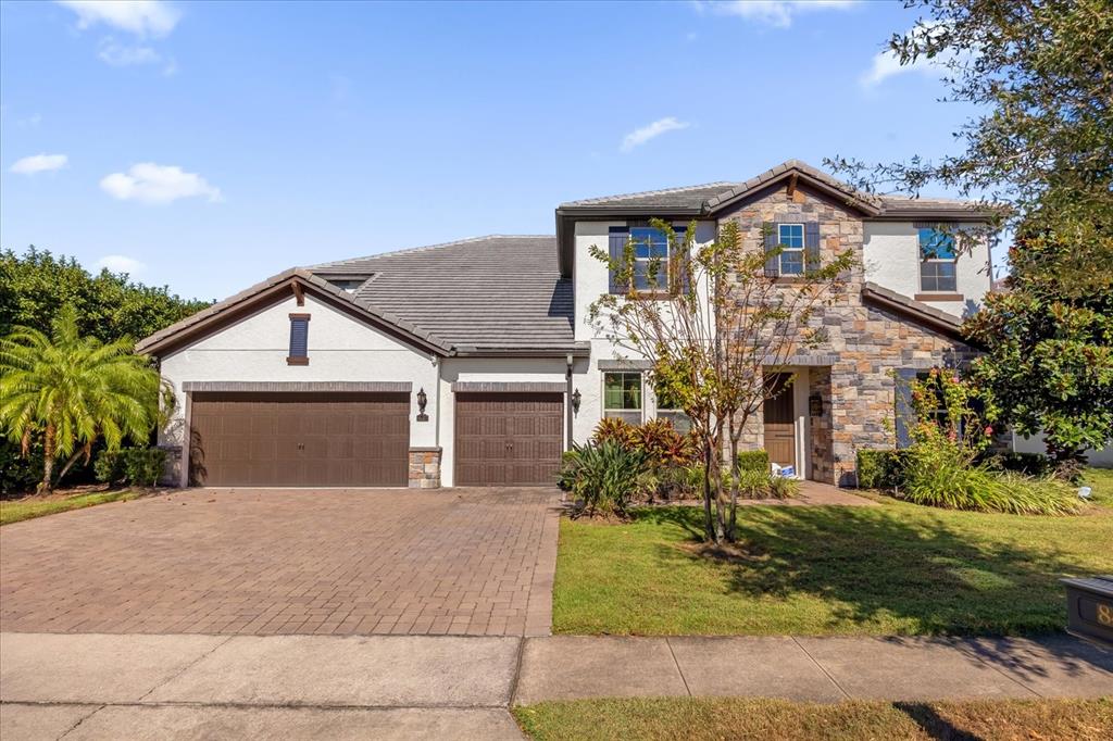 a front view of a house with a yard and garage