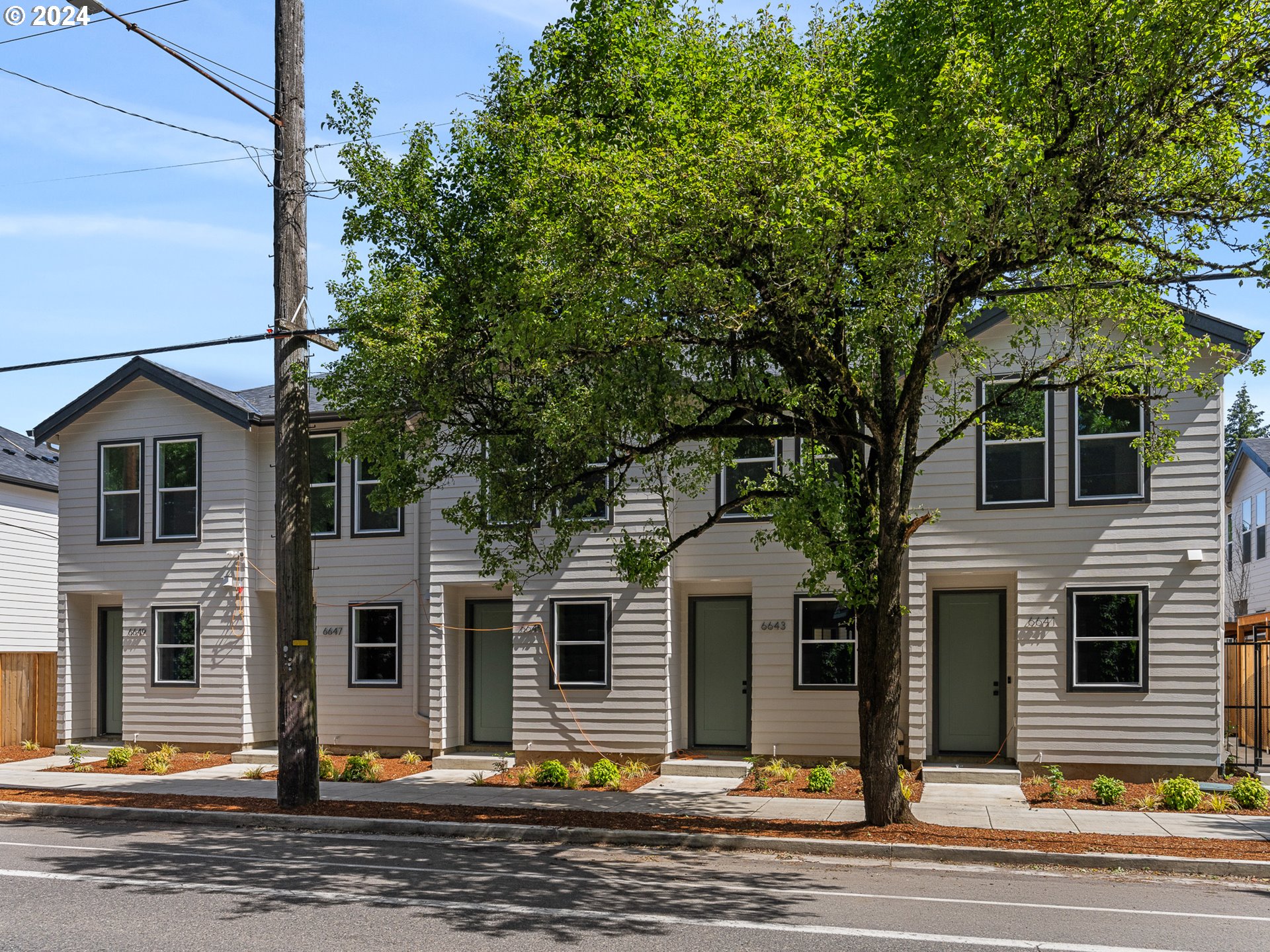 a front view of a house with a street