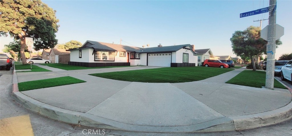 a view of a house with a yard and pathway