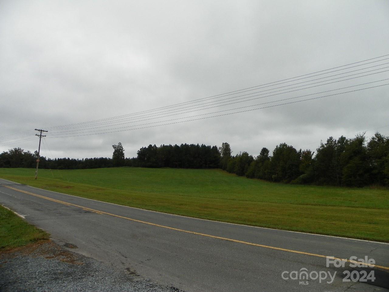 a view of a field with a building in the background