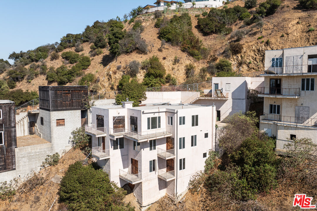 an aerial view of residential houses with outdoor space