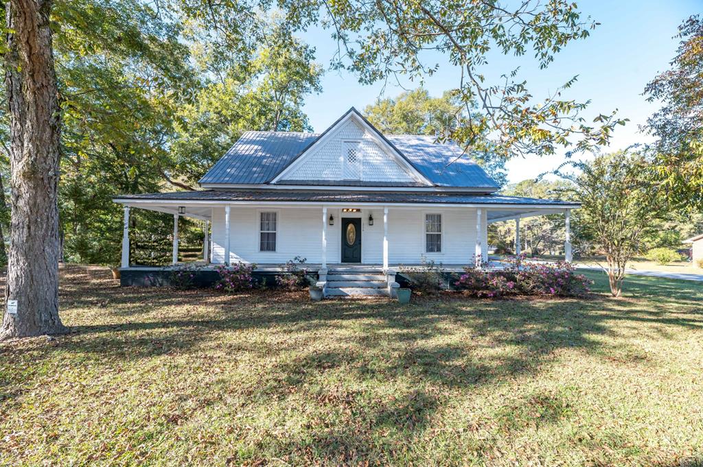 a front view of a house with a garden and porch