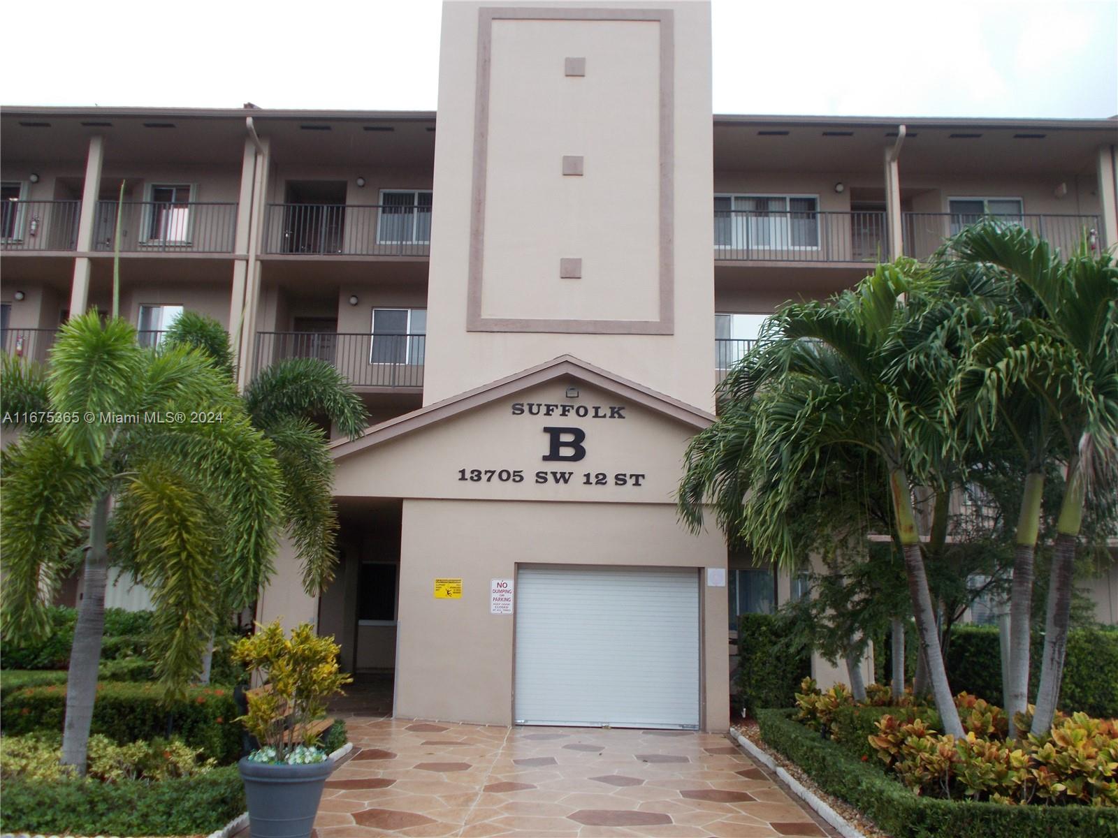 a view of a building with potted plants