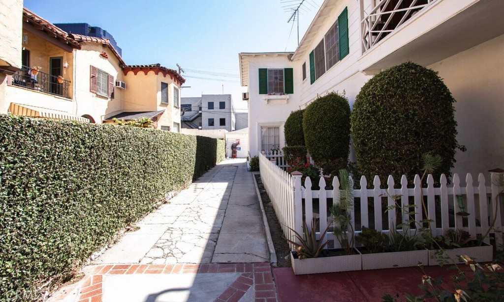 a view of a house with wooden fence