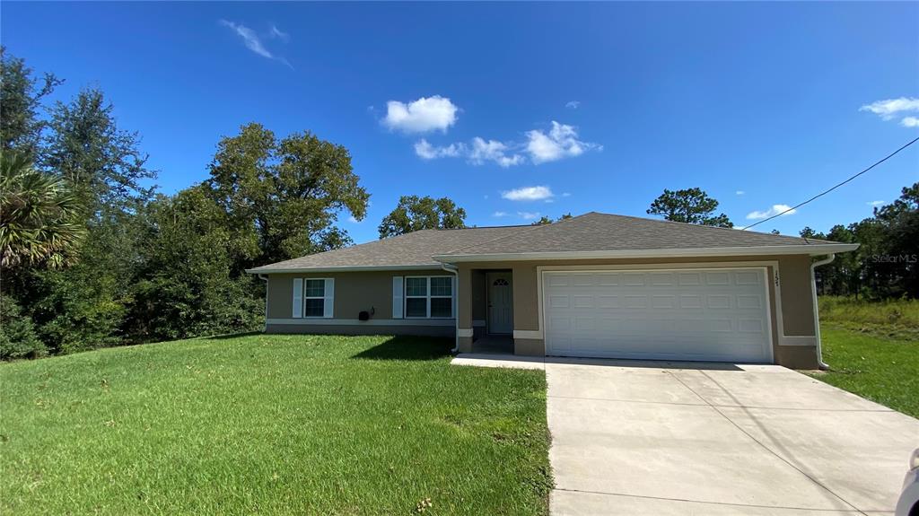 a front view of house with yard and green space