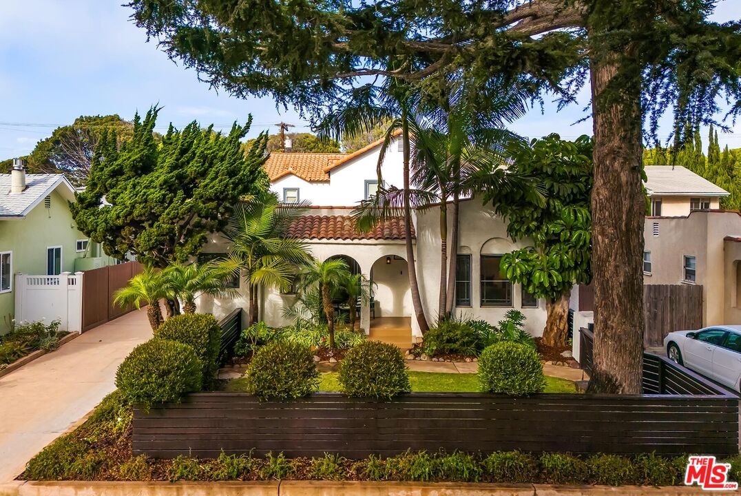 a front view of a house with lots of trees