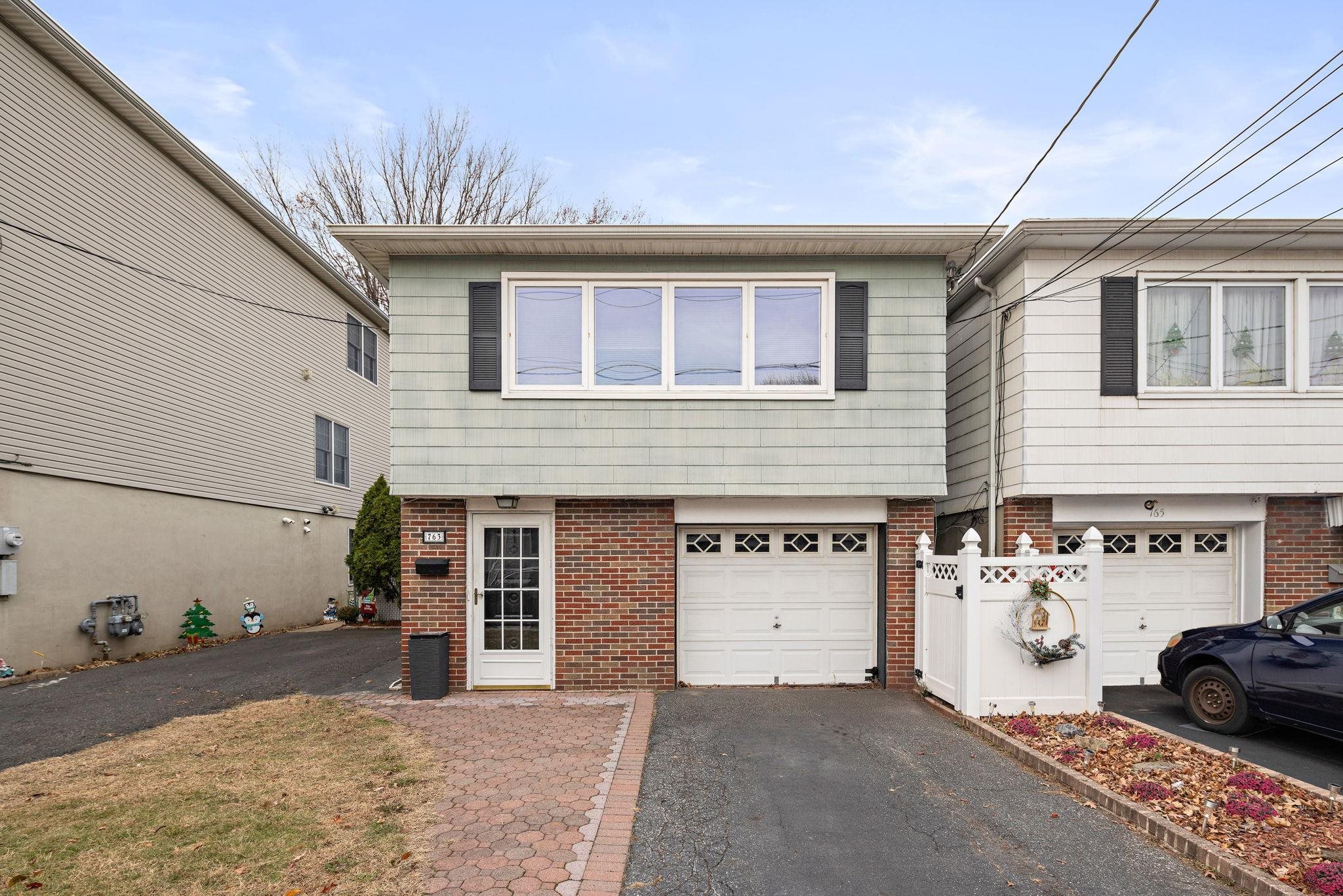 a front view of a house with parking space