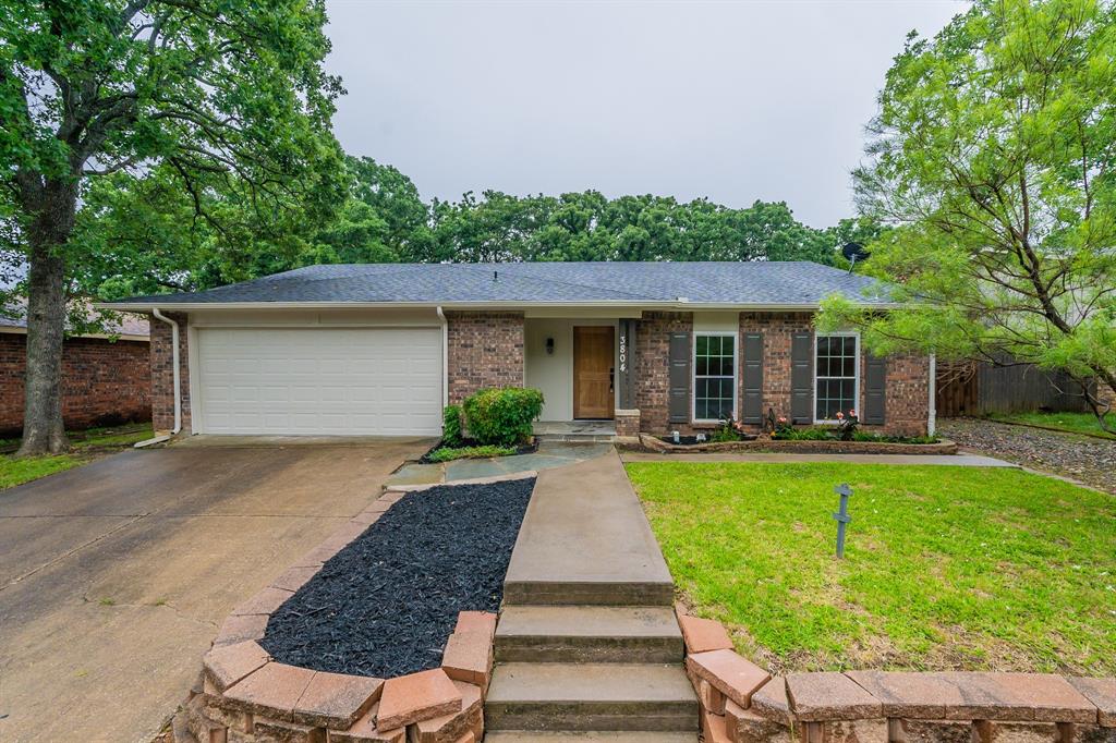 a front view of a house with yard patio and swimming pool