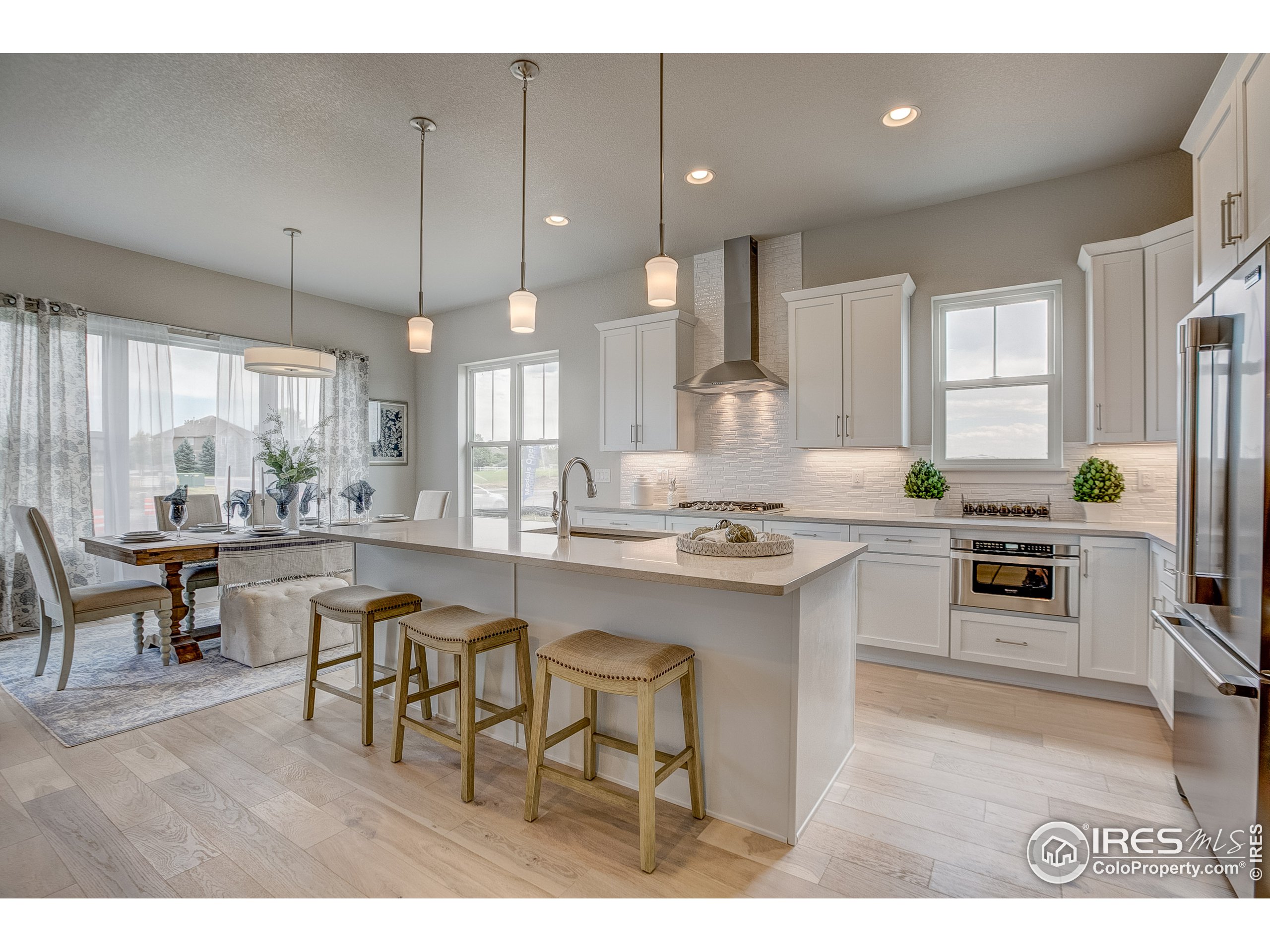 a kitchen with stainless steel appliances kitchen island granite countertop a sink and cabinets