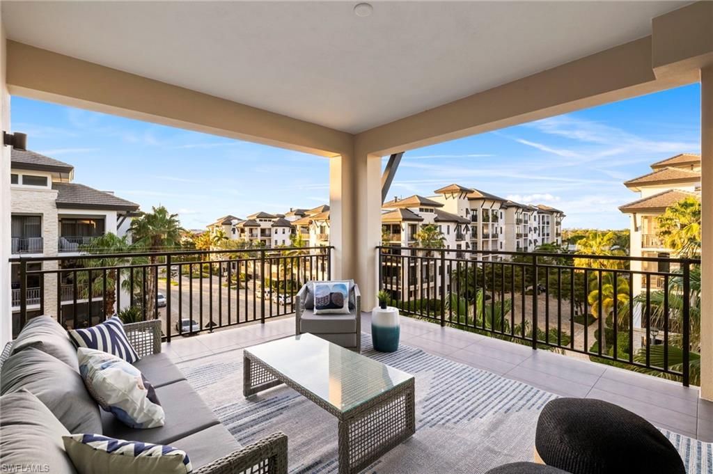 a balcony with furniture and city view