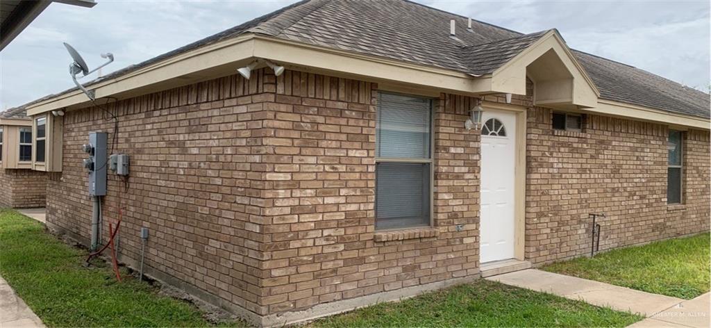 a brick building with a yard