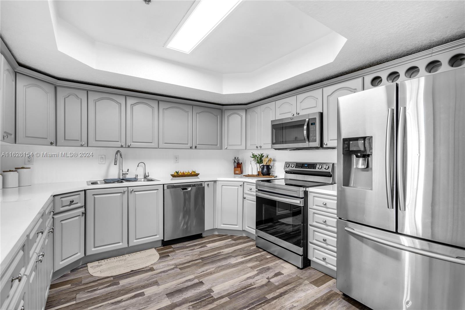 a kitchen with granite countertop a refrigerator stove and microwave