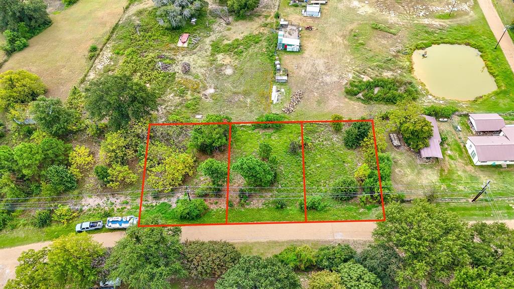 an aerial view of residential house with outdoor space and trees all around