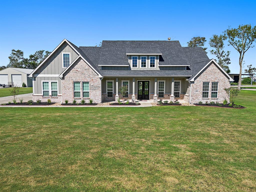 a front view of a house with a garden and plants