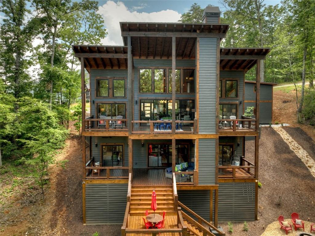 a front view of a house with swimming pool and glass windows