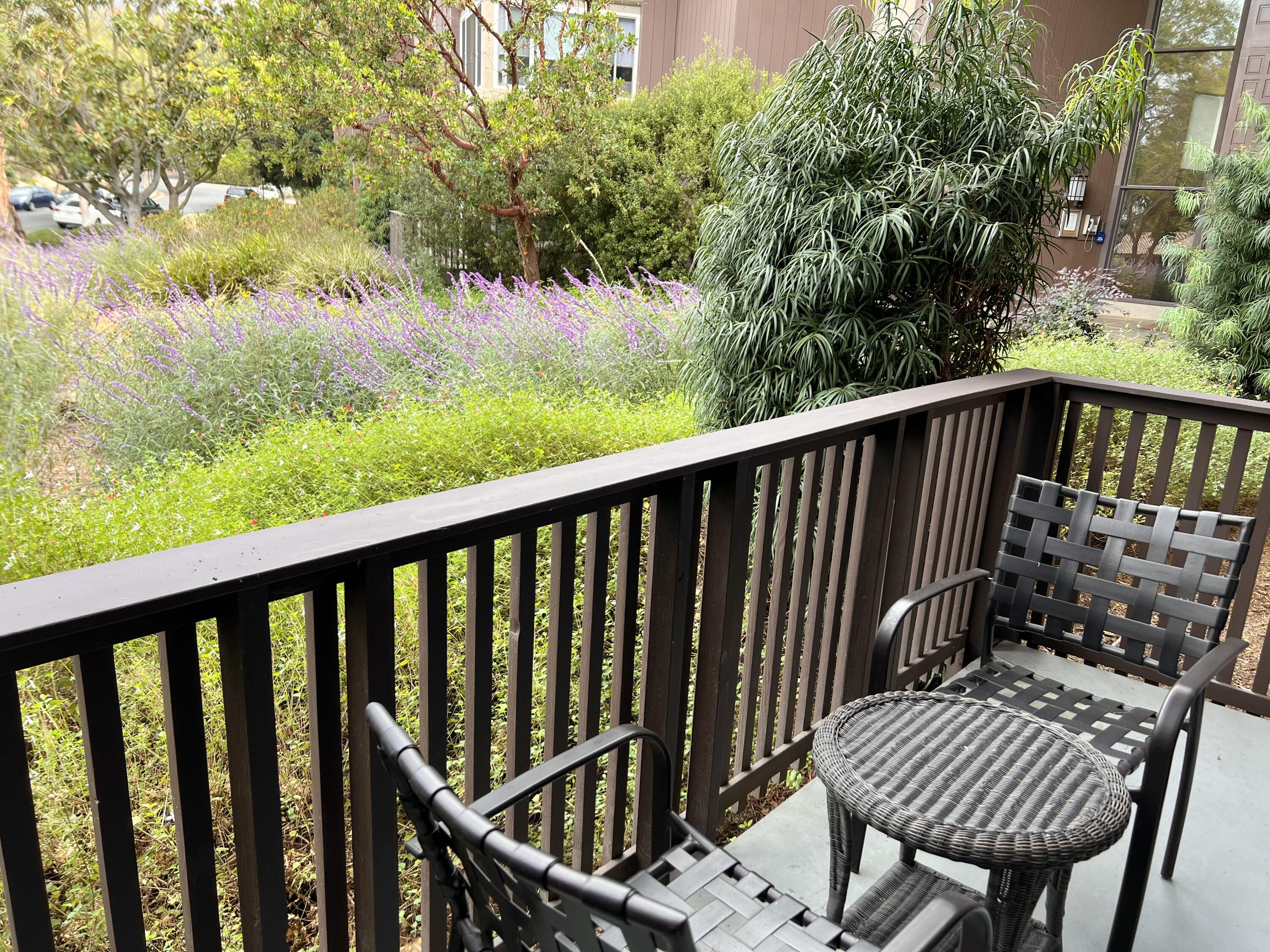 a view of balcony with wooden floor and outdoor seating