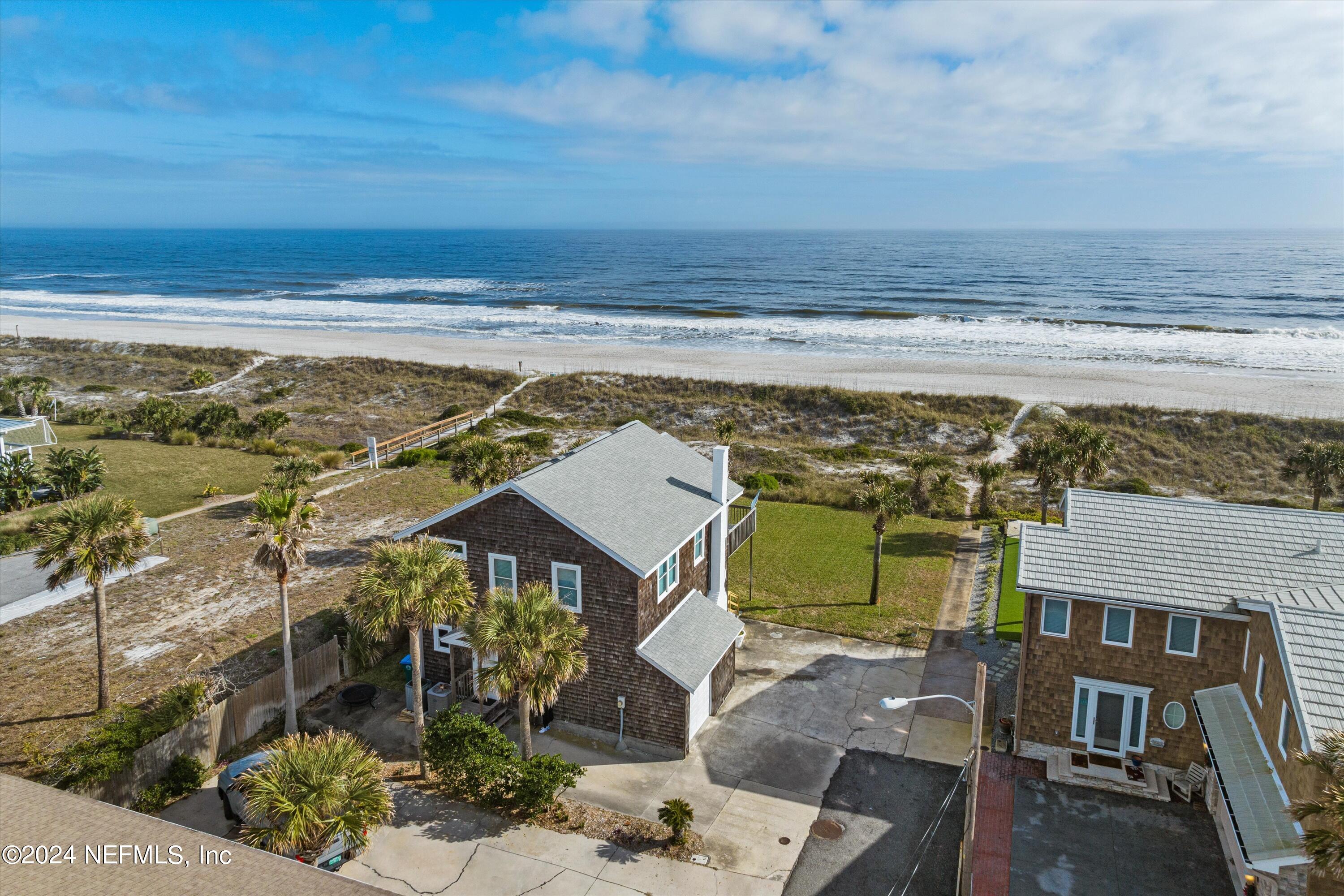 an aerial view of a house with a ocean view