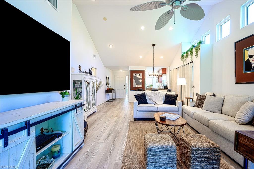 a living room with furniture flat screen tv and wooden floor