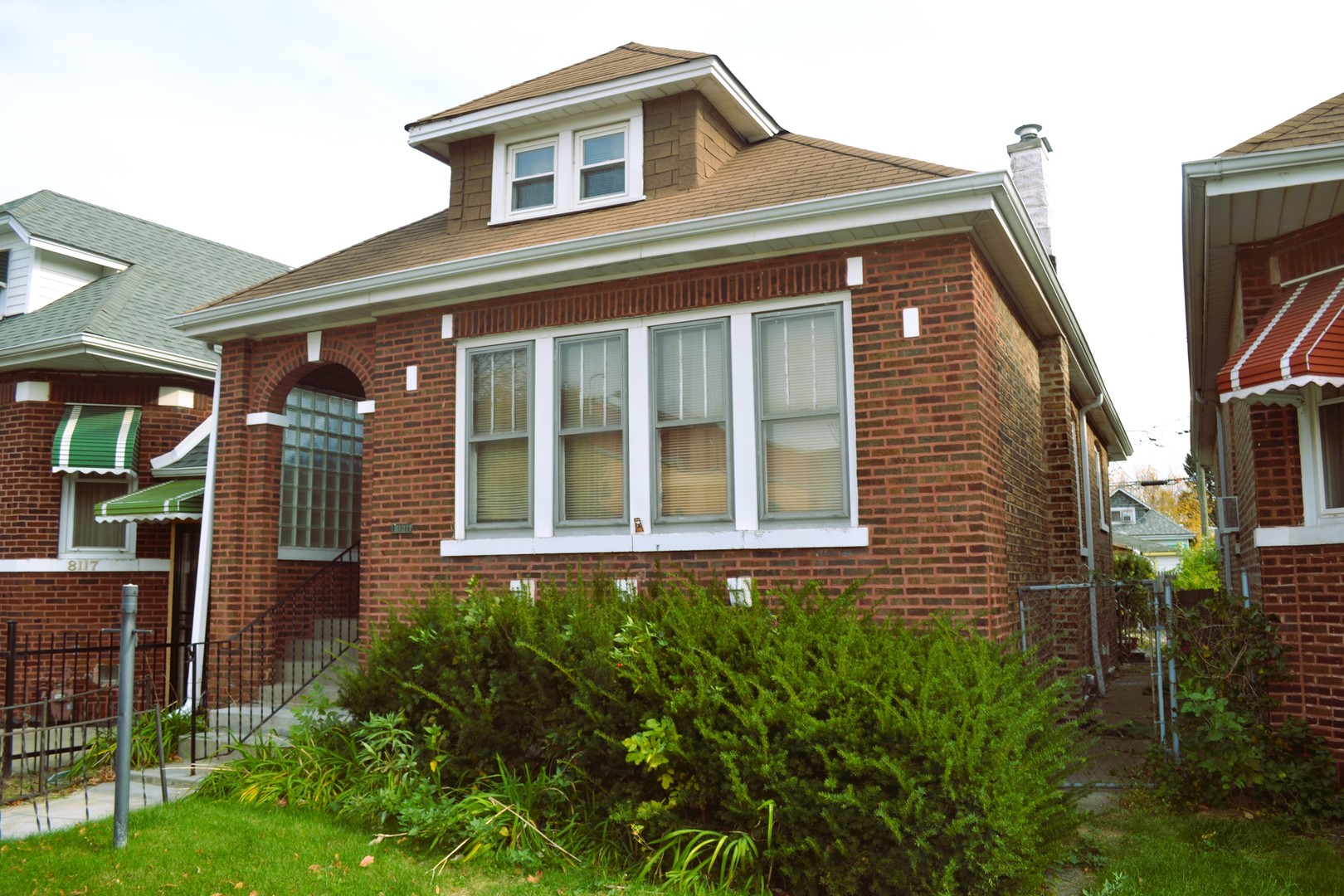 a view of a brick house with many windows