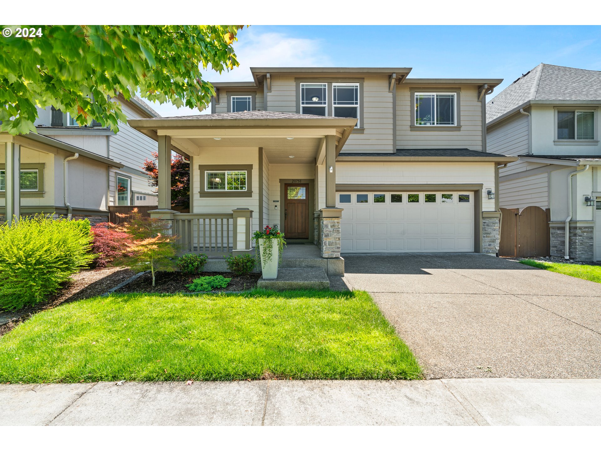 a front view of a house with a yard and garage