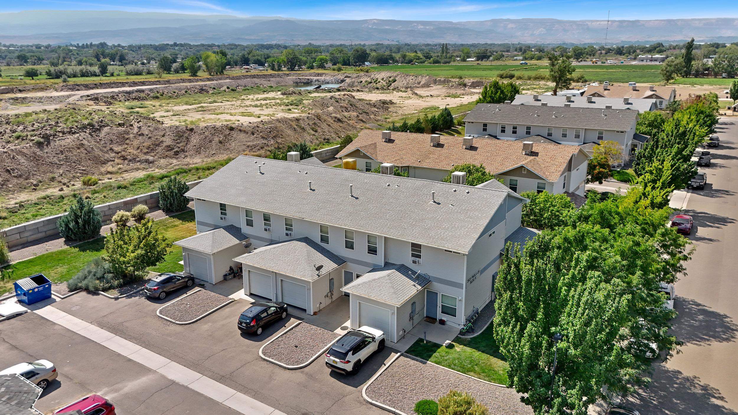 an aerial view of a house with a garden and lake view